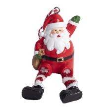 POLYRESINOVÝ SANTA CLAUS, MÁVAJÚCI, SO ZAVESENÝMI NOHAMI, ČERVENÝ