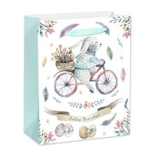 PAPIEROVÁ TAŠKA S MATNÝM POVRCHOM, S CHLOPŇOU ZO STUHY, BIELE POZADIE SO ZAJAČIKOM NA BICYKLI, ŠŤASTNÉ VEĽKONOČNÉ SVIATKY