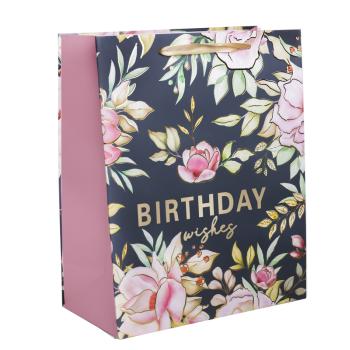 PAPIEROVÁ TAŠKA S MATNOU, LESKLOU POTLAČOU "BIRTHDAY WISHES" V ZLATEJ FARBE S RUŽOVÝMI KVETMI